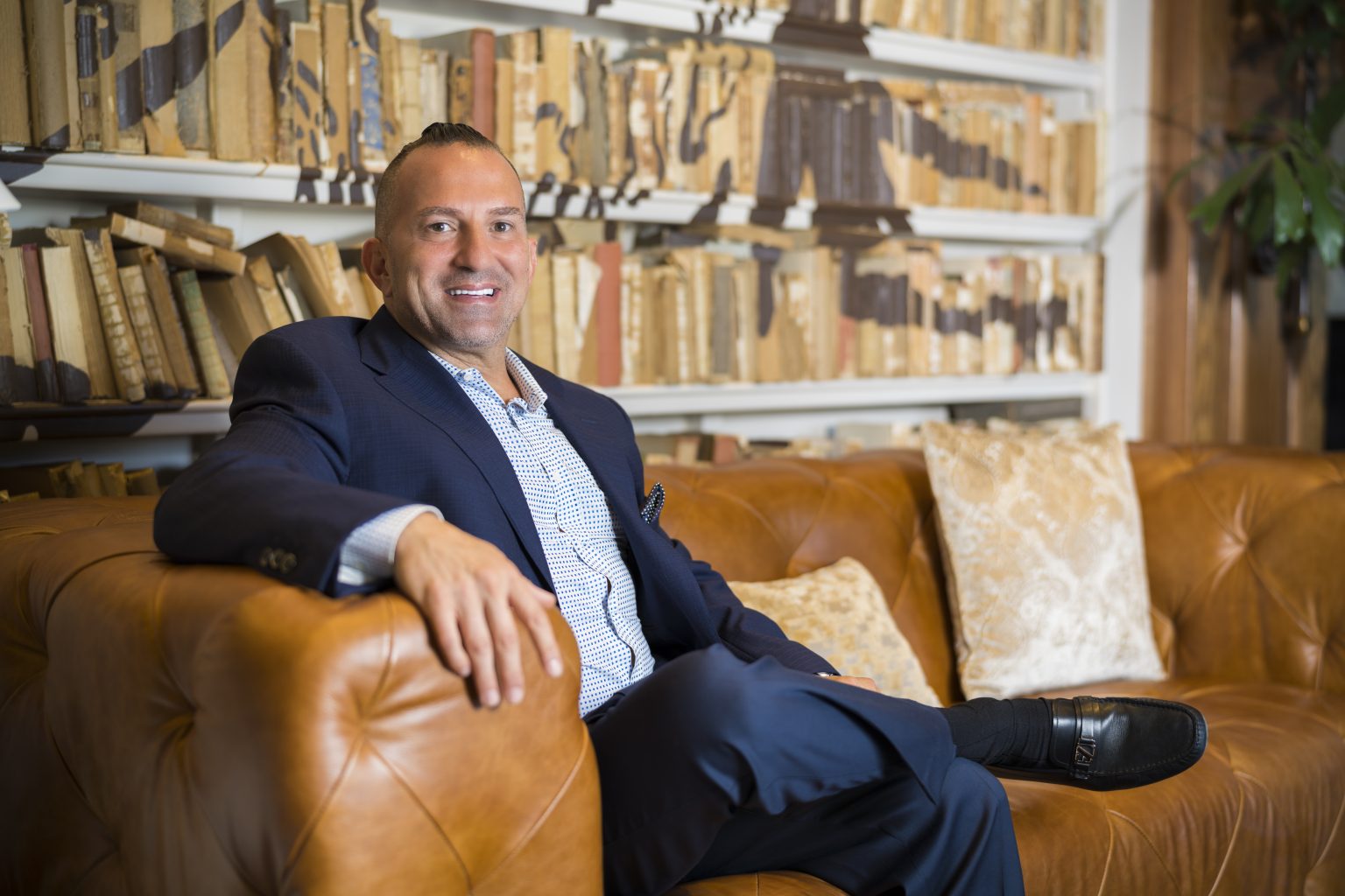 Farid Dallal seated in a library